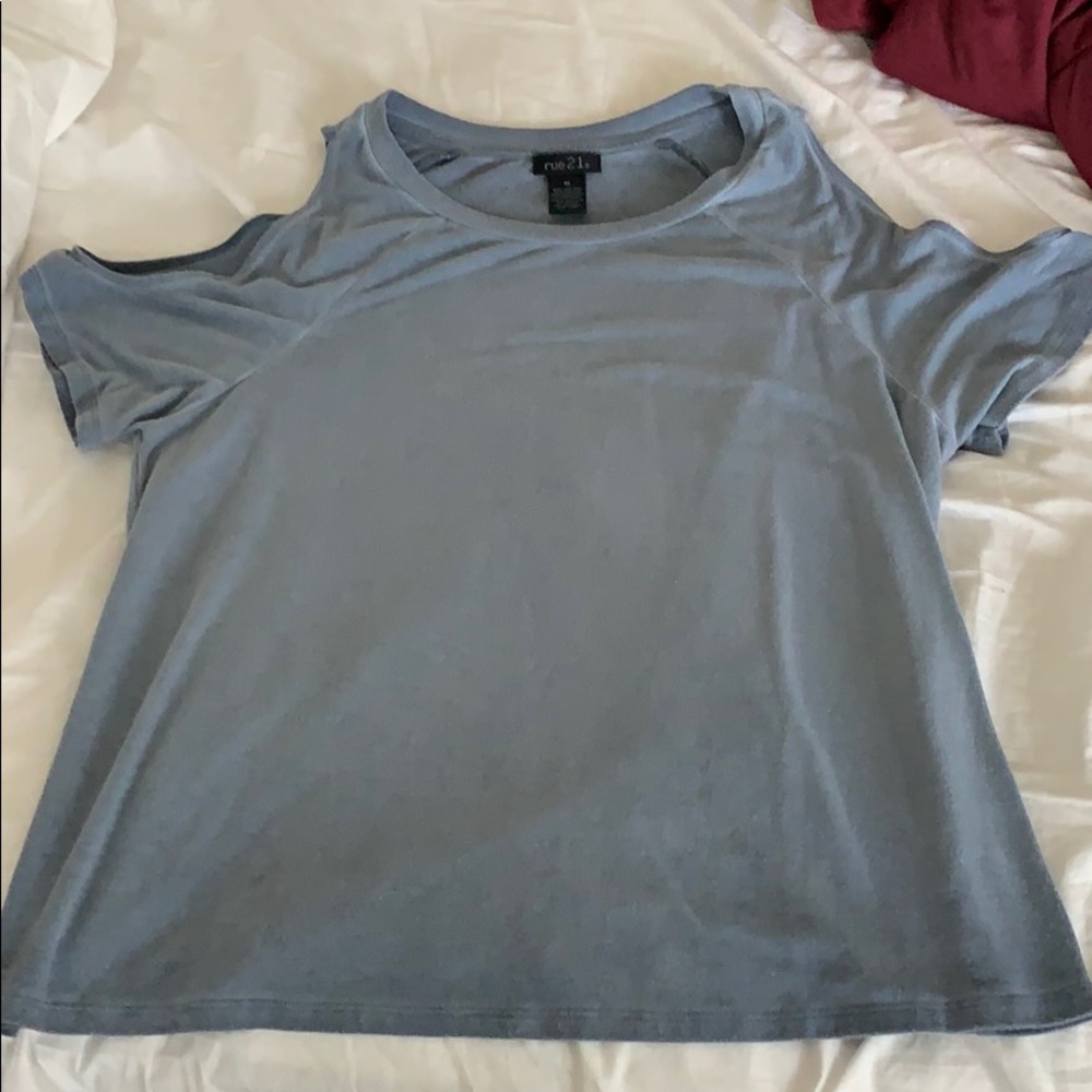 blueish shirt with shoulder cut